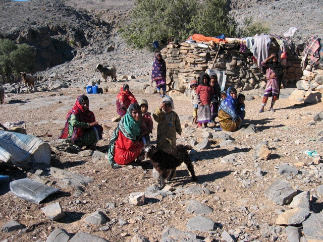 shawawiya family near stone hut, Oman